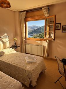 Alba de los CardañosHotel Pico Espiguete的一间卧室设有两张床和窗户。