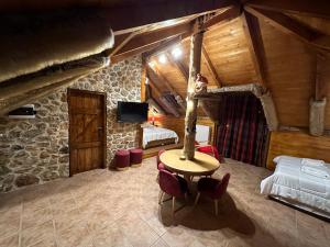 OítiΟ Σκίουρος Παραδοσιακοί Ξενώνες的一间卧室配有桌子、床和电视。