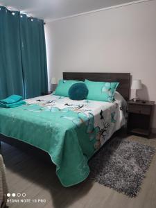 圣地亚哥Departamento nuevo y cómodo的一间卧室配有一张带绿色棉被的床