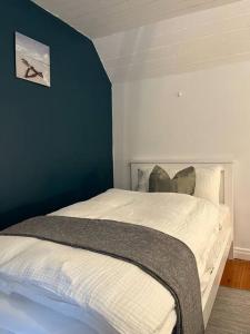新罗斯Sweet Lamb Farmhouse的卧室配有白色床和蓝色墙壁