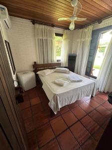 托雷斯Pousada House Sol & Praia的一间卧室配有一张床和吊扇