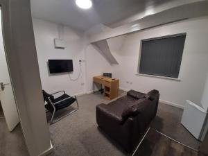 米德尔斯伯勒Exclusive Self-contained flat in Middlesbrough的客厅配有真皮沙发和椅子