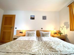 诺因多夫Süderhaus Hiddensee App 4的卧室配有一张带两个枕头的大白色床