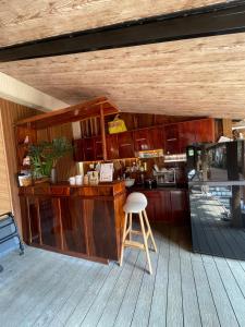 龙川市Lá Garden Homestay的甲板上的厨房,带柜台和凳子