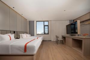 腾冲格林东方酒店(腾冲东湖公园店)的一间酒店客房,配有一张大床和一台平面电视