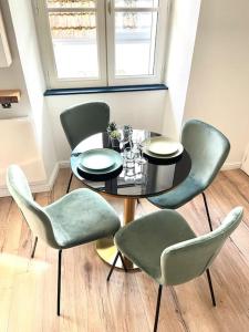波城Magnifique Appartement Hypercentre - Le Charly的一间带桌子和绿色椅子的用餐室