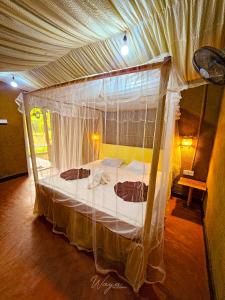 达瓦拉维Wild Safari Clay House的一间卧室,卧室内配有一张天蓬床