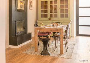 洛里昂RÉF 483 - LORIENT maison de ville avec terrasse jardinet的餐桌、椅子和壁炉