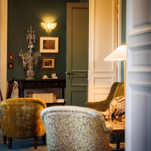 科尔维纳克Domaine de Locguénolé & Spa - Relais & Chateaux的客厅配有两把椅子和一张桌子