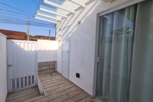 伯迪亚哥Studio 01的白色建筑中带玻璃门的阳台