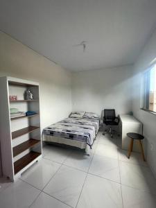 DianópolisApto Serras Gerais的一间卧室配有一张床和一张书桌