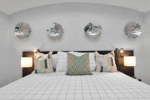 休斯顿Dreamy 3BDRM Museum/Med ctr Gem的卧室配有带枕头和两盏灯的白色床。