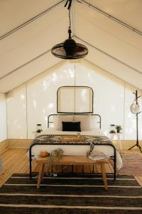 甘特斯维尔Luxury Glamping Tents @ Lake Guntersville State Park的一间卧室配有一张床和一张木桌