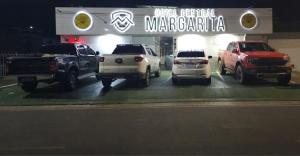 博阿维斯塔HOTEL CENTRAL MARGARITA的停泊在商船经销商前面的一组汽车