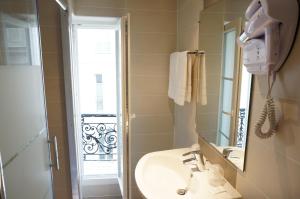 巴黎佐拉酒店的一间带水槽、镜子和淋浴的浴室