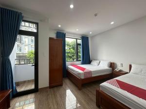 岘港OYO 1224 Motel Phuong Linh的一间卧室设有两张床和窗户。