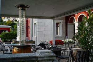 的里雅斯特波塔齐别墅酒店的一个带桌椅的庭院和一个喷泉
