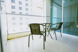 迪拜Citi home 1BR New Marina Sulafa Tower的配有大窗户的客房内的桌椅
