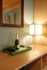 维罗纳Pietra di Verona Residenza的桌子上放有一瓶葡萄酒和两杯酒