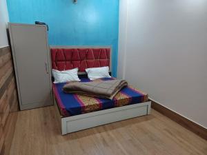 Rāni PokhriParadise Home stay的一张红色床头板的床