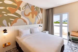 里约热内卢B&B HOTEL Santos Dumont的一间设有大床和窗户的酒店客房