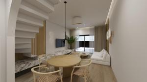 SarakinikoAnemolia Parga Suites的客厅配有桌椅和沙发