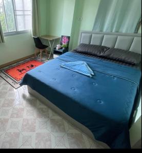 班达拉朗西JATUPORN A2的一间卧室,卧室内配有一张蓝色大床