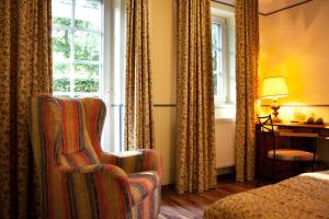 施特拉尔松德加戈霍夫兰德加斯托夫酒店的酒店客房设有椅子和窗户。