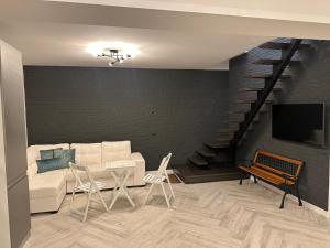 BorsaVacation house的客厅设有白色沙发和楼梯。