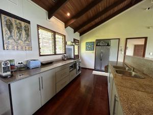萨武萨武Latui Lodge的一间大厨房,配有白色的橱柜和水槽