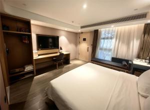 北京北京朝阳门亚朵酒店的酒店客房,配有床和电视