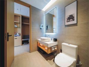 吉林丽柏酒店（吉林北山公园松花江店）的浴室配有白色卫生间和盥洗盆。