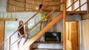 爱妮岛Happiness Vacation Villa El Nido的两人站在阁楼的楼梯上