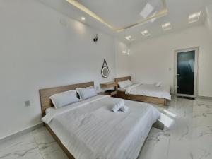 阿普春安CT Villa的白色墙壁客房的两张床