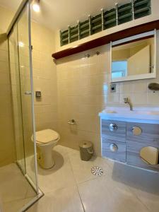 卡拉瓜塔图巴APTO DE FRENTE PARA O MAR - CARAGUATATUBA.的浴室配有卫生间、盥洗盆和淋浴。