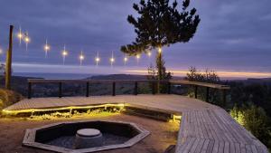 马坦萨斯Glamping Matanzas Lodge & Glamp的露台设有火坑,甲板上设有灯光