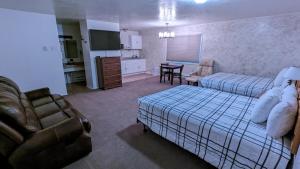 萨利纳High Desert Inn的一间卧室配有一张床和一张沙发,还设有一间厨房