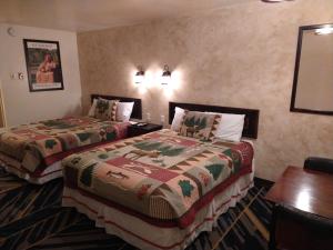 萨利纳High Desert Inn的酒店客房设有两张床和一张桌子。