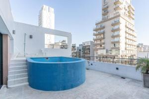 布宜诺斯艾利斯Acacia Beautiful Studio的建筑物屋顶上的蓝色浴缸