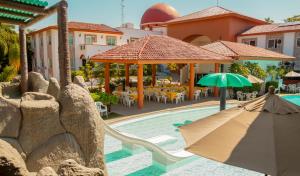 科利马玛丽亚伊莎贝尔酒店 的游泳池配有遮阳伞和桌椅