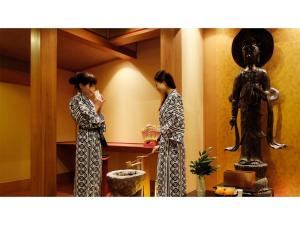 三朝町Mansuirou - Vacation STAY 32147v的两个女人在一间有雕像的房间