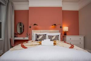 High HeatonThe Saint George的卧室配有白色大床和橙色墙壁