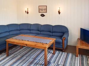 Holiday home VEGA II的客厅配有蓝色的沙发和茶几