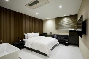 首尔艺术家驿三汽车旅馆的一间卧室配有一张床、一张桌子和一个水槽