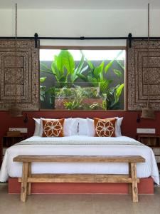 吉利阿尔Lasai Villas的一间卧室设有一张大床和一个窗户。