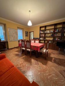 Gattico奥池迪比安卡住宿加早餐旅馆的一间用餐室,配有红色的桌子和椅子