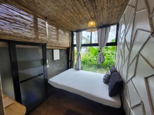 卢纳将军城Tarzan's House的小房间设有床和窗户