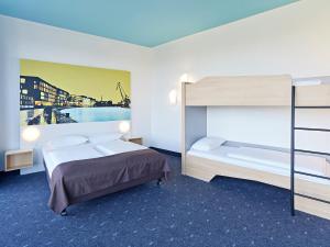 明斯特B&B HOTEL Münster Hafen的一间卧室配有一张床和一张双层床。