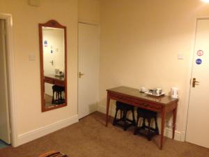 霍利韦尔维多利亚酒店的酒店客房设有一张桌子和一面镜子