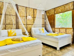 八打雁Dreamland Paradise Resort的配有黄色床单的客房内的两张床